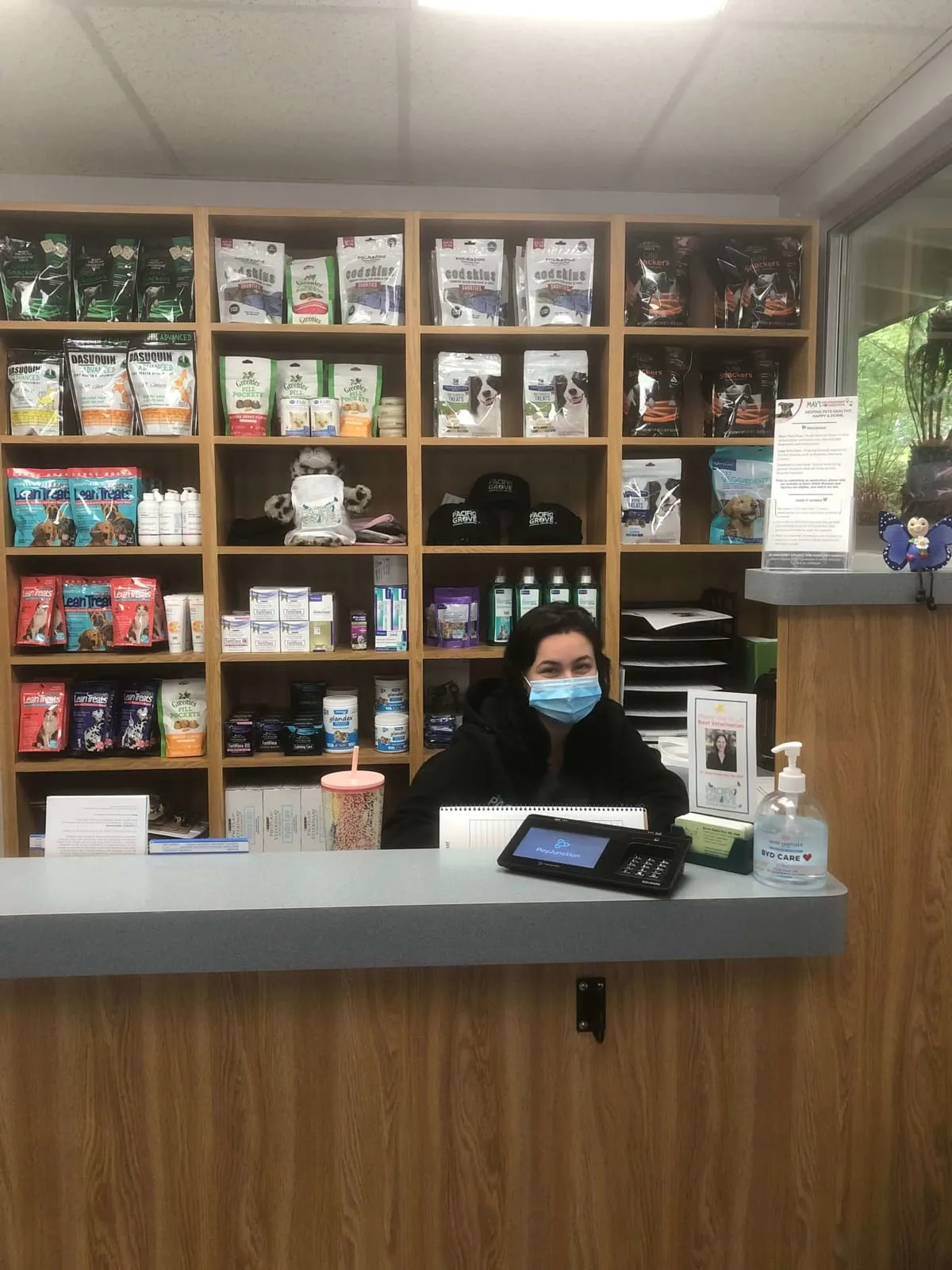 The reception desk with a wall of pet food and supplies