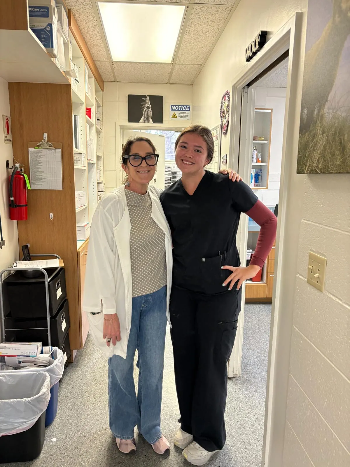 Two team members standing together in the hospital hallway