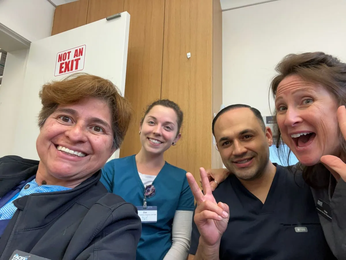 Four team members taking a cheerful selfie